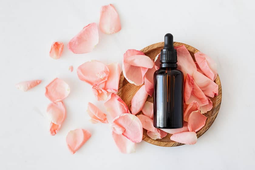 a bottle oil lying on rose patels