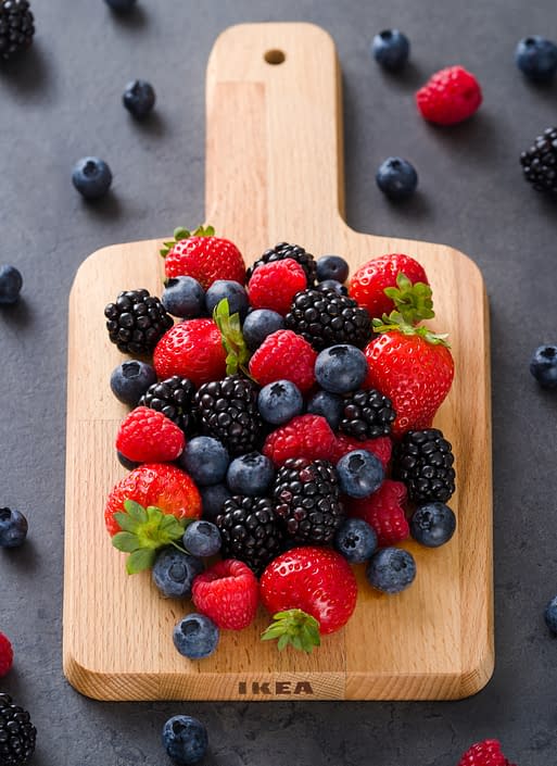 different berries on a wooden plank