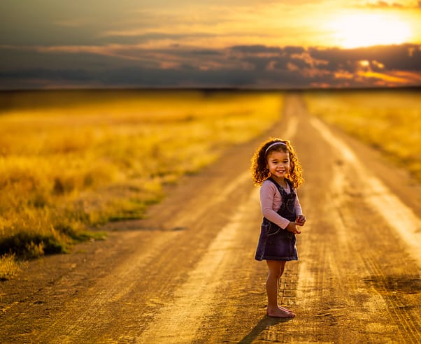 small girl in a sunset on a path