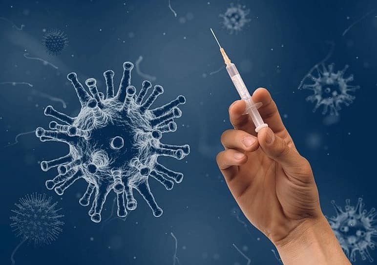 a virus, and a hand with an injection needle