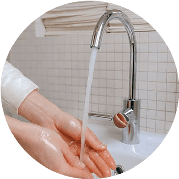 A tap with flowing water, two hands washing