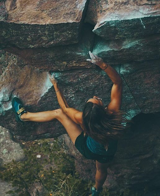 woman climbing in a wall of a mountain
