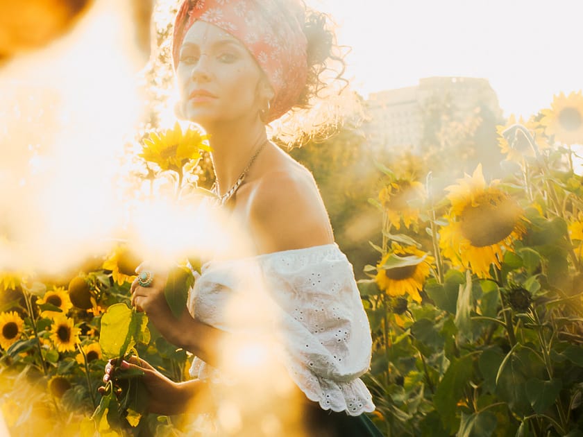 woman in a flowerfield, sun is shining
