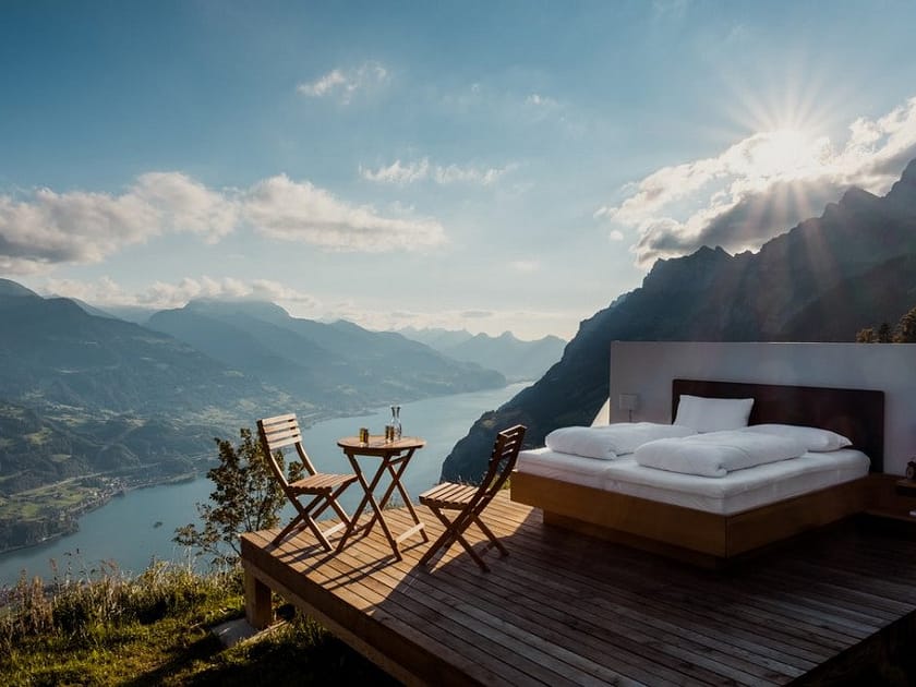 a bed high up on a terrace in the mountains